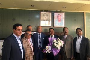 IOF officials greet new BTRC Chairman with a bouquet of flowers at his office.